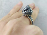 Unleash your edgy side with our one of a kind silver dome ring. Featuring thorns that add a unique touch, this unusual ring is the perfect gift for any goth woman. Shop abroad online and elevate your jewelry collection today!
