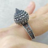 These one-of-a-kind silver jewelry pieces feature dome-shaped earrings with thorns and unique rings perfect for a gothic woman's gift. Handcrafted with silver 925 stumped, these pieces are available exclusively from an Armenian jewelry store. Add a touch of edginess to your accessories collection with these unusual and expertly designed items.