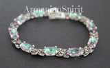This bracelet is a captivating blend of vintage charm and modern shimmer, making it a truly eye-catching piece. The combination of the intricate, almost antique-looking marcasite with the vibrant, almost otherworldly rainbow green stone creates a striking juxtaposition that's hard to ignore. The green stone is the star of the show. Depending on the light, it seems to shift in color, revealing hints of blues, greens, and even hints of gold. It's truly mesmerizing and adds a touch of magic to the design.