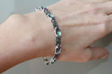 Are you searching for a piece of jewelry that combines elegance, durability, and unique beauty? Look no further than a sterling silver 925 bracelet adorned with marcasite and rainbow green stone. This stunning accessory boasts many benefits and is sure to become a staple in your jewelry collection. Sterling silver 925 is a standard used to describe silver alloyed with other metals, typically copper, to increase its strength and durability. The "925" denotes that the alloy contains 92.5% silver.