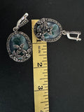 These one of a kind, feminine and classic silver earrings feature a 2 inch oval dangle design with stunning flower marcasite and oval moss agate green gemstones. Perfect for grandmas, these unique earrings are a must-have addition to any jewelry collection.