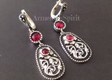 A set of sterling silver jewelry, featuring floral long earrings and a ring, with red garnet stones. The jewelry is displayed against a white background with the Armenian Spirit brand visible. This is not just jewelry—it’s a piece of Armenian culture. The best Armenian sterling silver shop connects people through heritage and design. All items are shipped directly from Armenia to you. The store is known to be safe, secure, and reliable.