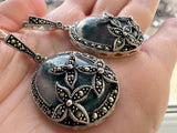 Upgrade your jewelry collection with these one of a kind silver earrings with oval moss agate green gemstones. The feminine flower marcasite design adds a touch of elegance to any outfit. These classic and unique earrings are sure to make a statement. Enhance your beauty with our one of a kind silver jewelry featuring oval dangle large earrings decorated with marcasite flowers and oval moss agate green gemstones. This classic and feminine design is perfect for grandma jewelry, making it unique.
