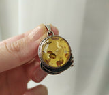 Expertly crafted in a unique round shape, this honey amber pendant is a stunning, one-of-a-kind addition to any jewelry collection. Made from natural gemstones, it offers both affordability and quality. Perfect for those looking for an affordable yet beautiful piece.