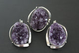 Imagine a statement piece that commands attention: large, handcrafted earrings, each featuring a captivating amethyst drusy geode. The deep, mesmerizing purple of the crystals, sparkling like a thousand tiny stars, contrasts beautifully with the cool gleam of the sterling silver 925 setting. These earrings are not simply accessories; they're wearable art, each unique and one-of-a-kind thanks to the natural variations within the geode itself. Flanked by these dramatic earrings, a truly impressive ring.