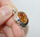 This beautiful, one-of-a-kind pendant features a round, natural honey amber gem. Its unique design and affordability make it a must-have accessory for any jewelry lover. Add a touch of sophistication to your collection with our affordable honey amber pendant.