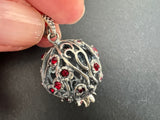 Elevate your jewelry collection with our high quality silver pomegranate pendant. Featuring red stones and a modern design, it makes the perfect holiday gift. The pomegranate net adds a unique touch to this elegant piece.
