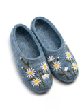 Blue slippers with round toe made of authentic merino wool with chamomile flowers embroidery on a white background.