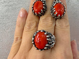 Expertly crafted with the finest materials, this high quality jewelry is sure to impress. Made with stamped sterling silver 925 and featuring a bright orange almost red agate natural gem, this one of a kind set includes a large ring and earrings, perfect for vintage lovers. Elevate any outfit and make a statement with this unique artisan jewelry.

