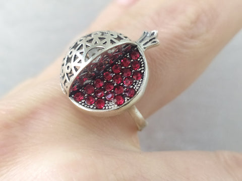 Armenian pomegranate jewelry is a real wanted gift for any Armenian woman and girl. This pomegranate ring is made of sterling silver and red small bright stones like pomegranate seeds. On the ring you also can see armenian traditional ornaments.