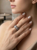 Close-up of a hand wearing a silver modern ring made by Armenian jewelers  with a blurred indoor background