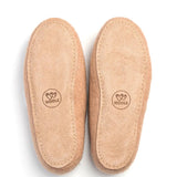 A pair of tan suede slip-on shoes shown from the sole side.