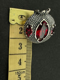 This Sterling Silver 925 handmade Armenian jewelry features a beautiful pomegranate brooch with a red transparent stone. Made by skilled artisans, this 1-inch pin brooch is perfect for adorning dresses and hats. Add a touch of Armenian culture and sophistication to your outfit with this unique piece.
