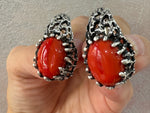 Expertly crafted artisan jewelry made with high quality sterling silver and a bright, natural agate gemstone in a stunning orange-red color. Each piece is one of a kind, making it the perfect gift for vintage lovers. Includes a large ring and earrings for a statement look. uy orange gemstone earrings matching to retro vintage dress with orange flowers.