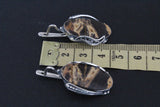 This handmade Armenian jewelry features a unique combination of coconut jasper stones in caramel yellow and brown, expertly crafted with high-quality sterling silver. Each piece is one-of-a-kind, making it a truly special addition to your collection. Elevate any ensemble with this stunning and unique one of a kind accessory.
