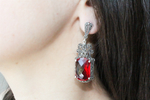 Presenting the ultimate accessory for the modern queen. These very large cosplay earrings, part of our Armenian Spirit collection, feature a stunning red stone and shiny marcasite accents. Made with high-quality sterling silver 925, perfect for any actress or performer looking to make a grand statement on and offstage.