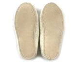 A pair of beige suede insoles with white sherpa lining, shown from the bottom against a white background.