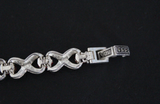 a pic showing a bracelet from reverse side and clasp with 925 stamp on a black surface.