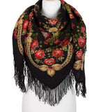 Close-up of a premium black and red merino wool scarf, highlighting the soft, heavy weave of the dark fabric and its intricate woolen fringes, styled like a traditional Slavic winter blanket shawl with large red roses and golden ornaments.