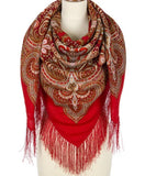 A large, opaque merino wool shawl in rich red, showcasing intricate Slavic paisley patterns draped elegantly around a mannequin torso.