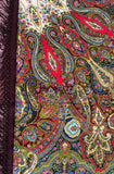 Close-up view of a multicolored floral pattern scarf crafted from soft merino wool, showcasing large pink and red paisley pattern in Indian style against a white background.