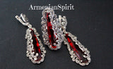Elegant jewelry set composed of a massive silver ring and matching long pendant earrings. The elongated, clear red gems are enveloped in a complex web of silver spirals and tiny marcasite crystals. This combination creates a striking, radiant contrast that elevates any formal attire.
