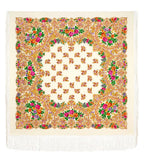 A large, cozy merino wool shawl in an ivory hue, decorated with traditional Slavic floral patterns in yellow, pink, and orange, finished with long fringe detailing. Product lifestyle shot of a cozy, blanket-style winter shawl made from 100% merino wool. The fabric has an ivory base heavily decorated with detailed folk ornaments in warm shades of orange, yellow, and bright pink, styled in an enveloping, protective wrap.