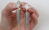 A set of sterling silver 925 jewelry including a dome ring and a pair of long earrings with traditional Armenian patterns.
