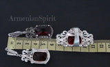 Armenian Spirit long Tudor dome earrings in sterling silver with marcasite accents and central red stones near a ruler.