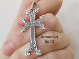 A large silver Armenian cross with traditional designs, displayed alongside a sterling silver chain.