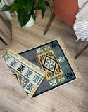 Decorative rug with geometric pattern on a wooden floor