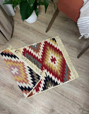 Decorative rug with geometric pattern on a wooden floor