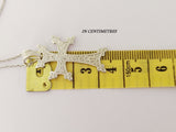 Armenian small cross with eight points and eternity wheel on a yellow ruler showing 3 cm.