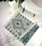 Decorative rug with geometric pattern on a tiled floor