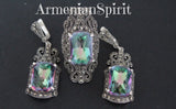 A pair of sterling silver earrings with green mystic topaz stones and small marcasite accents, displayed against a black background with the brand name 'Armenian Spirit' written at the top.