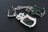Rich, luxury-style extra large Tudor dome ring and long earrings featuring brilliant faceted green emeralds and bright marcasites in handmade silver.