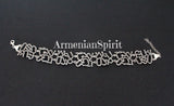 Wide Armenian letter silver bracelet showcasing the full alphabet on a woman's wrist, handcrafted luxury jewelry by Armenian Spirit.