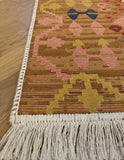 Decorative rug with fringe on a wooden floor