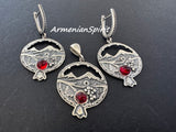 Silver jewelry set with pomegranate design, Armenian symbols and red stones on a black background, branded 'Armenian Spirit'.