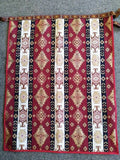 Armenian rectangle apron with traditional patterns and ornaments in burgundy and white.