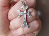 A silver Armenian cross necklace with traditional herbal designs and Armenian eternity wheel in the middle, displayed against a white background with 'ArmenianSpirit' written at the bottom.