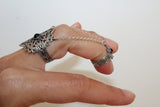A woman ring on the middle finger with traditional Armenian ornaments and black tiny stone made of sterling silver 925.