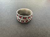 Upgrade your style with our high quality silver jewelry band ring. The sleek design features red dots that perfectly complement a red and white dots dress. Made with premium silver, this jewelry piece is a must-have for any fashion-forward individual.
