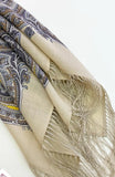 Beige and gray women`s scarf with paisley pattern and tassels on a white background