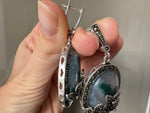 Elevate your style with our one of a kind silver jewelry featuring oval dangle earrings and a stunning combination of flower marcasite and oval moss agate in a beautiful green hue. This feminine and classic design is perfect for any occasion and makes for a unique addition to your jewelry collection. A timeless piece that any grandma will love.
