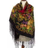 Colorful peony floral patterned cashmere like merino wool scarf with fringes on a mannequin against a white background