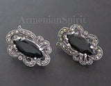 A pair of sterling silver 925 earrings featuring marcasite stones and black topaz, with intricate designs.