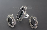 A pair of sterling silver 925 earrings featuring marcasite stones and black topaz, with intricate designs.