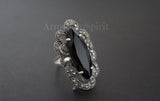 A pair of sterling silver 925 earrings featuring marcasite stones and black topaz, with intricate designs.
