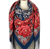 Colorful Slavic vintage floral patterned scarf on a mannequin with a white background. The trim has a fringe and the shawl is with large red vintage peony flowers.
